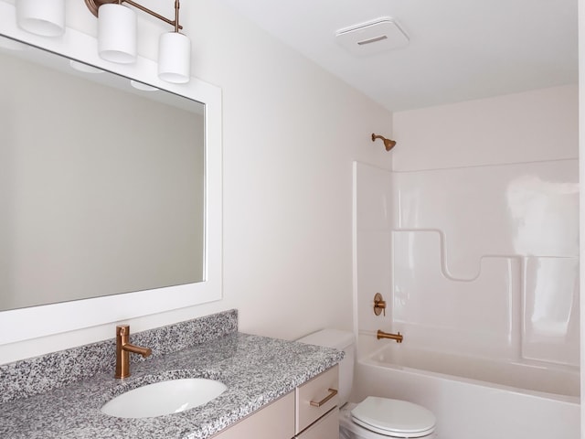 bathroom featuring tub / shower combination, vanity, and toilet