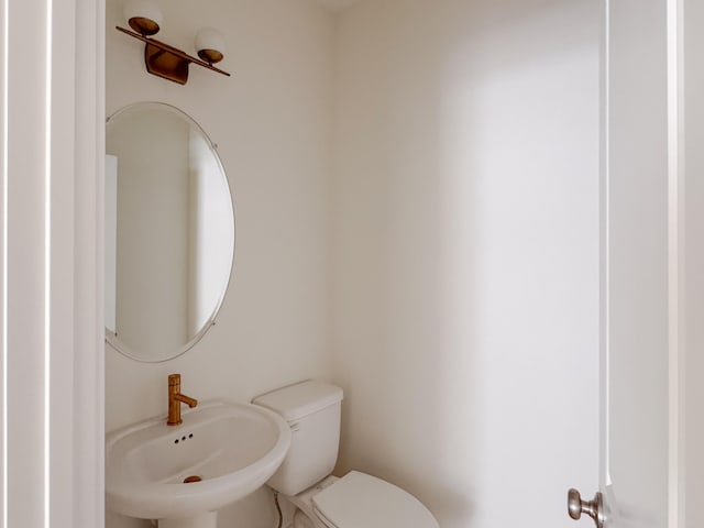 bathroom featuring toilet and sink