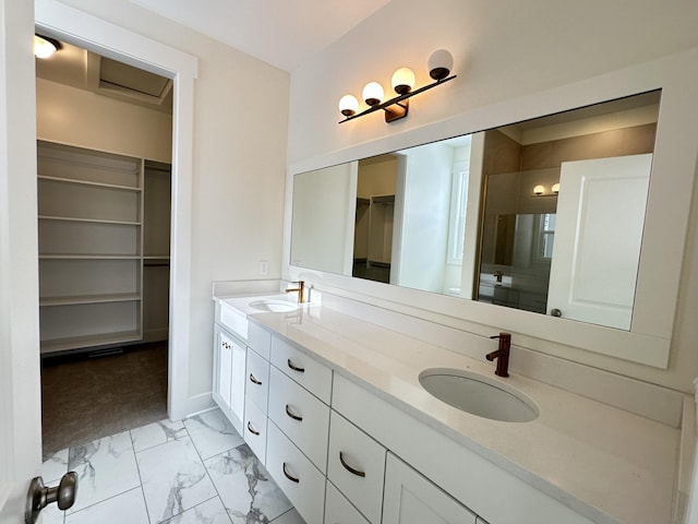 bathroom featuring a shower with door and vanity