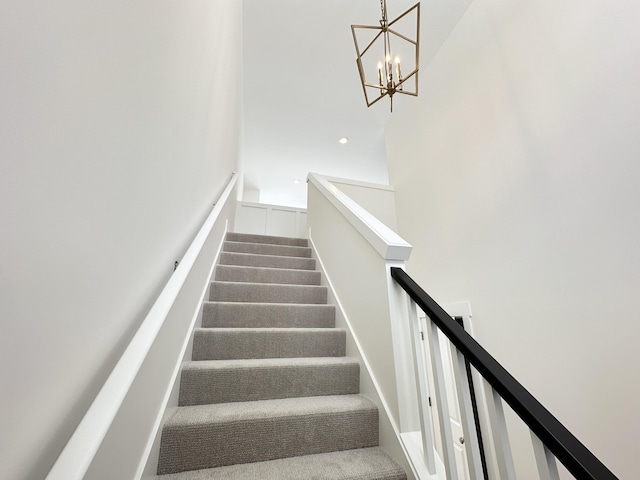 stairs with a chandelier