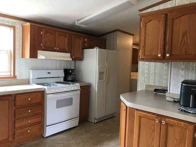 kitchen with ornamental molding and white appliances