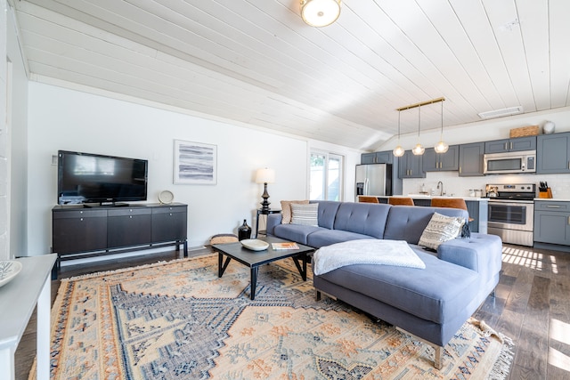 living room featuring hardwood / wood-style floors, sink, wooden ceiling, and lofted ceiling