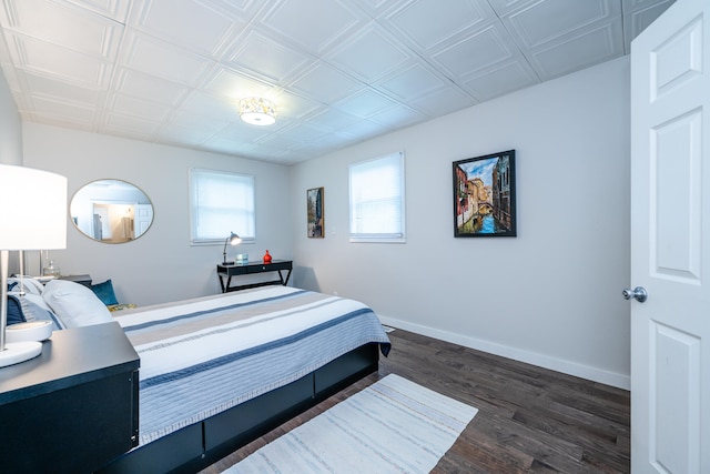 bedroom with dark wood-type flooring