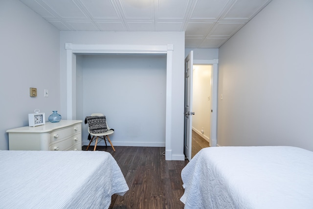 bedroom with a closet and dark hardwood / wood-style flooring