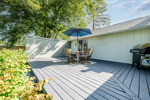 wooden terrace featuring a grill