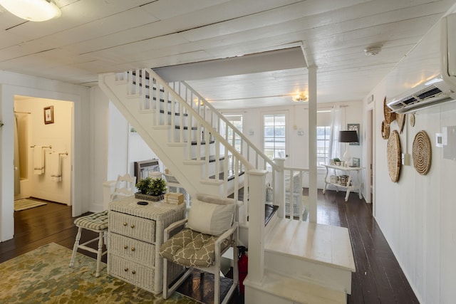 staircase with hardwood / wood-style floors, cooling unit, wood ceiling, and a wall mounted AC