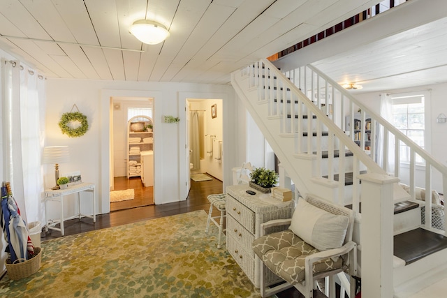 staircase with wooden ceiling and wood finished floors