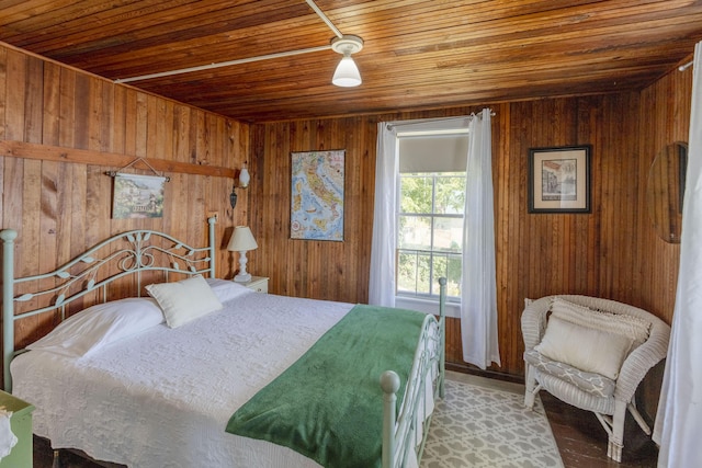 bedroom with wooden walls and wood ceiling