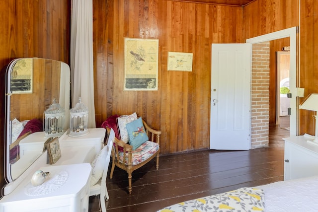 bedroom featuring wood-type flooring and wood walls