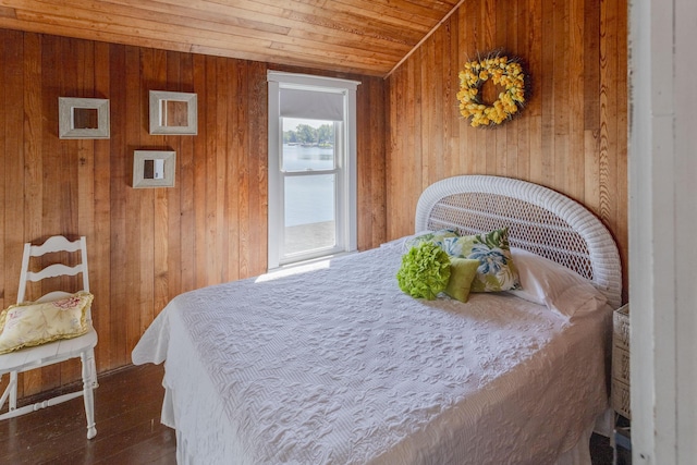 bedroom with wooden ceiling, wood finished floors, and wood walls