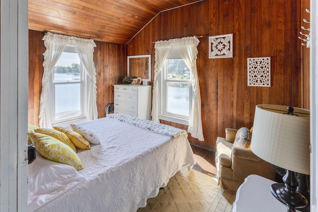 bedroom with wood ceiling, multiple windows, wooden walls, and lofted ceiling