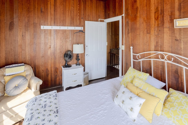 bedroom featuring wooden walls