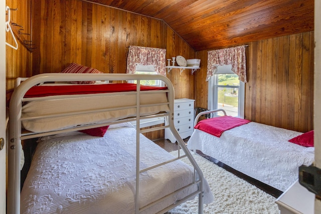 bedroom featuring lofted ceiling, wood ceiling, and wood walls