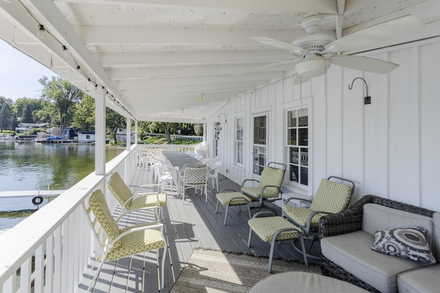 view of patio / terrace with a ceiling fan and a water view