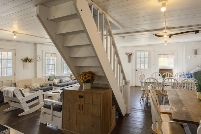 living room with stairway, wooden ceiling, and dark wood-type flooring