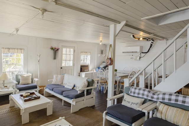 living room featuring wooden ceiling, stairway, wood finished floors, and a wall mounted air conditioner