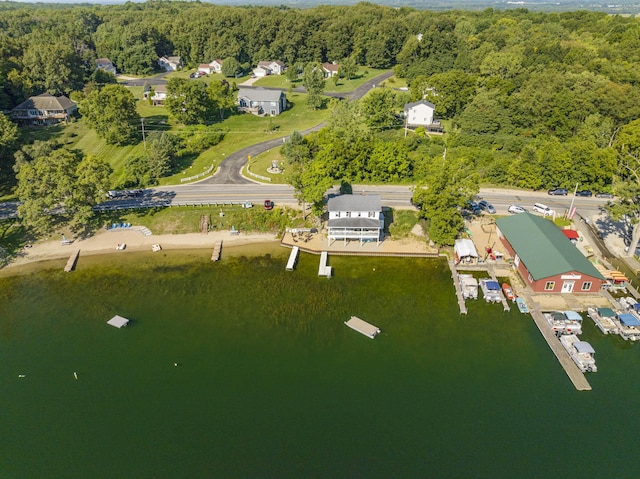 aerial view with a forest view and a water view