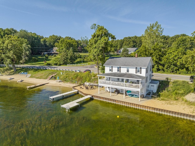 back of house featuring a deck with water view