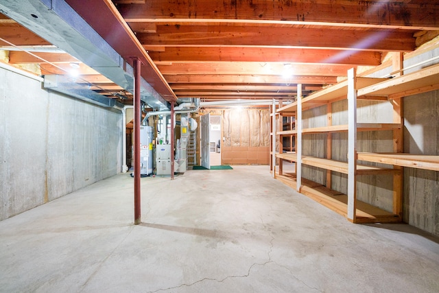 basement featuring water heater and heating unit