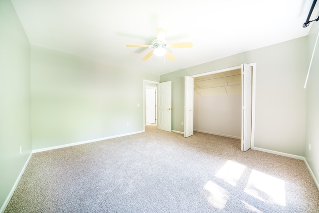 unfurnished bedroom featuring light colored carpet, a closet, and ceiling fan