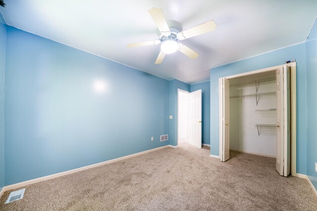 unfurnished bedroom featuring ceiling fan, light carpet, and a closet