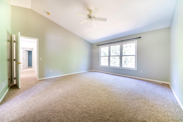 carpeted spare room featuring lofted ceiling and ceiling fan