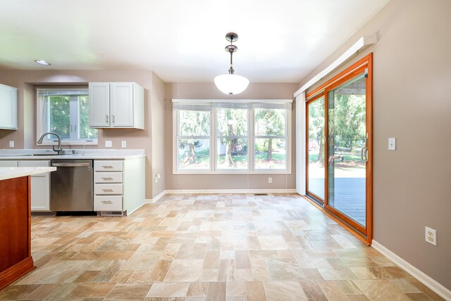 kitchen featuring white cabinetry, dishwasher, plenty of natural light, and pendant lighting