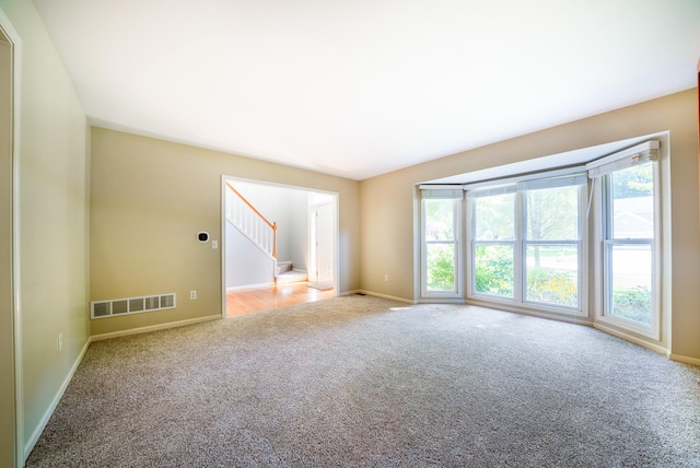 carpeted spare room with a healthy amount of sunlight