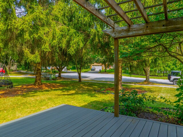 deck with a yard and a pergola