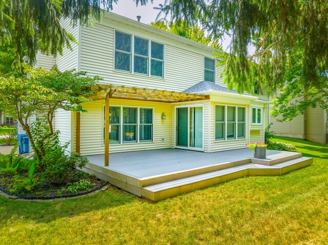 rear view of property featuring a yard, a pergola, and a deck