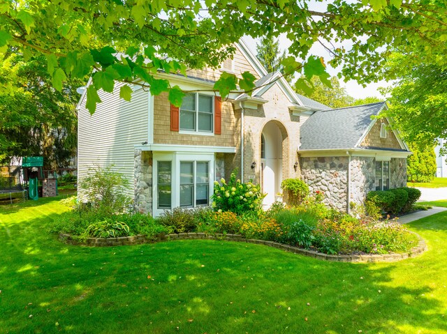 view of front of property with a playground and a front yard