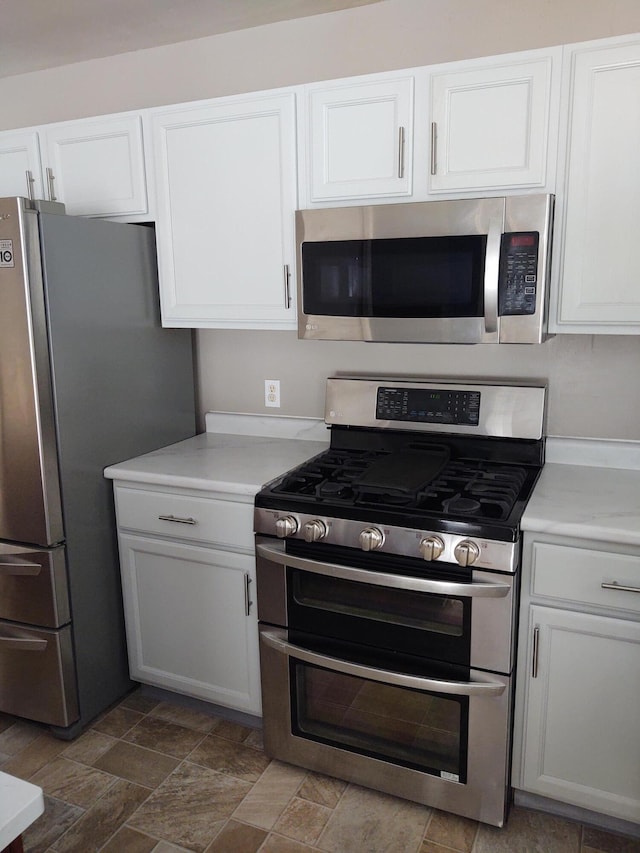 kitchen featuring stainless steel appliances and white cabinets