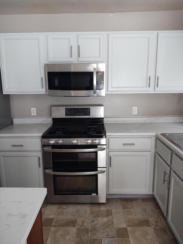 kitchen featuring white cabinets and appliances with stainless steel finishes