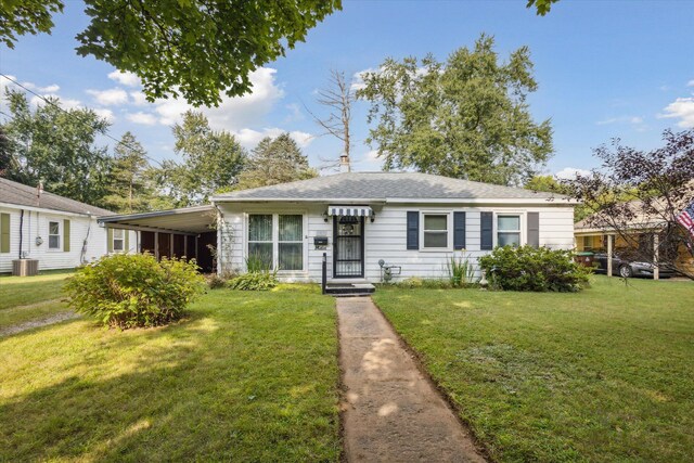 view of front of property featuring central air condition unit and a front yard