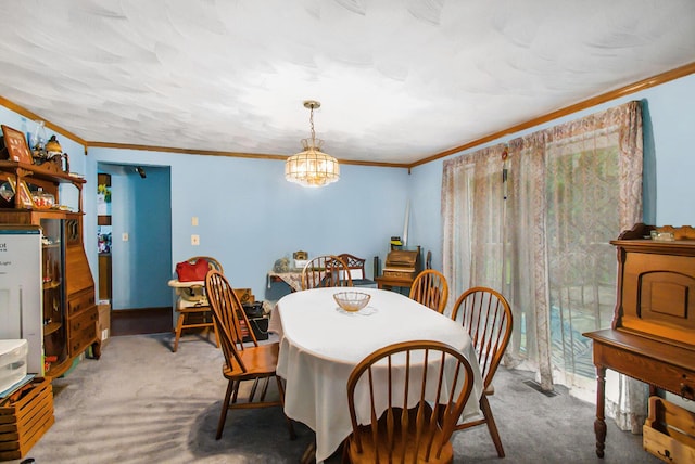 carpeted dining space featuring a chandelier, visible vents, and crown molding