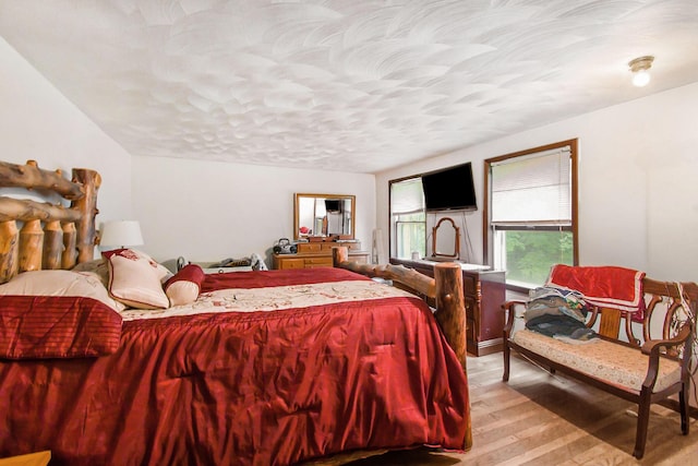 bedroom featuring light wood-style flooring and a textured ceiling