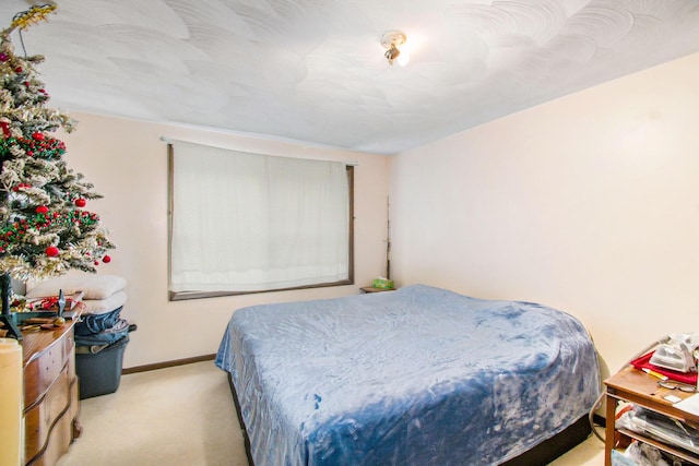 bedroom with carpet and baseboards