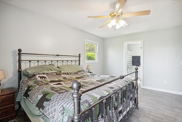 bedroom with ceiling fan, a textured ceiling, and hardwood / wood-style floors