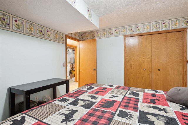 bedroom with a textured ceiling and a closet