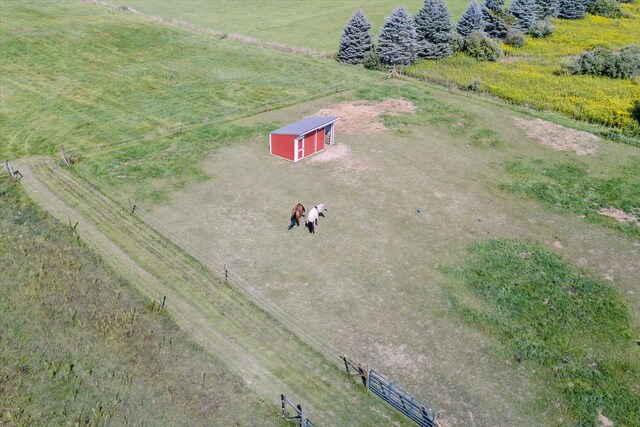 birds eye view of property with a rural view