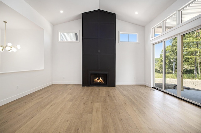 unfurnished living room featuring a fireplace, baseboards, light wood-style floors, and vaulted ceiling