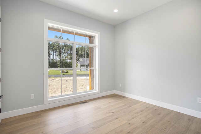 empty room with recessed lighting, baseboards, and light wood-style floors