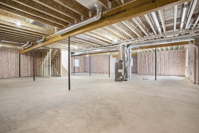 below grade area featuring gas water heater and stairs