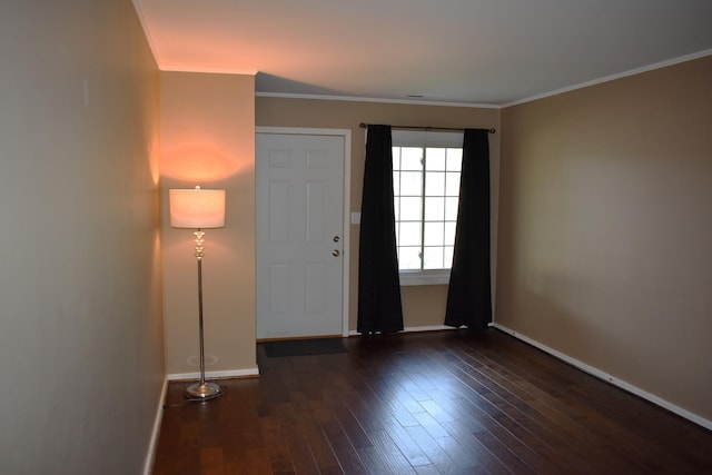 entryway featuring wood finished floors, baseboards, and ornamental molding