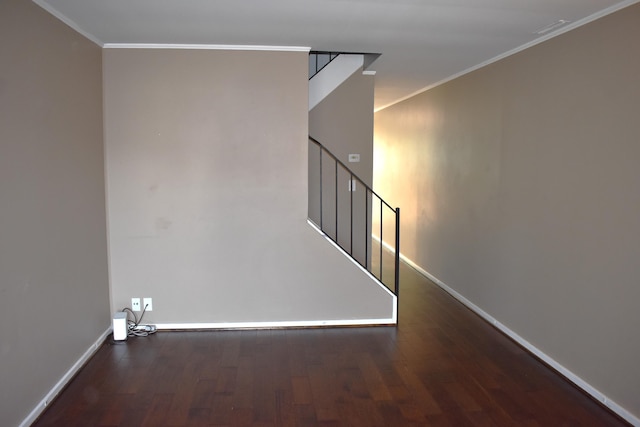 unfurnished room with crown molding, stairway, wood finished floors, and baseboards