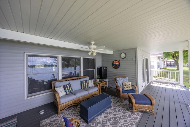 deck with outdoor lounge area and ceiling fan