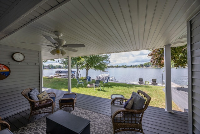 view of patio featuring a deck with water view and ceiling fan