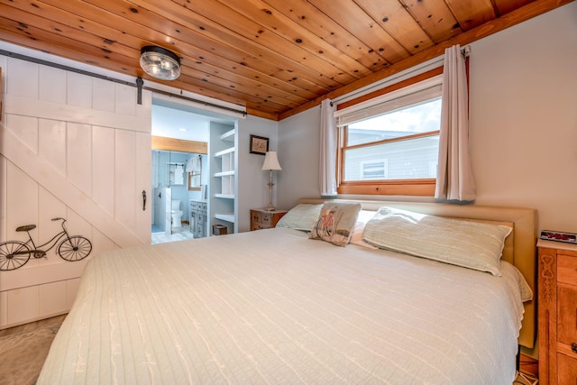 bedroom with a barn door, light colored carpet, and wooden ceiling