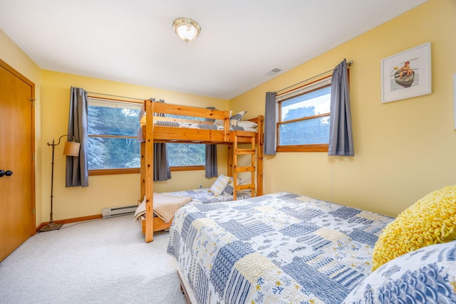 bedroom featuring a baseboard heating unit and carpet flooring