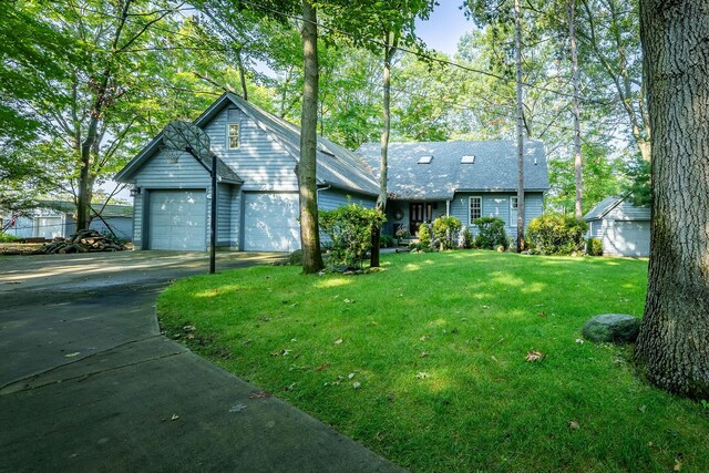 view of front of house featuring a garage and a front lawn